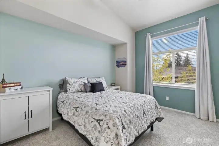 Spacious primary bedroom with soaring ceilings