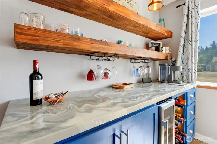 Beautiful beverage bar with mini fridge.