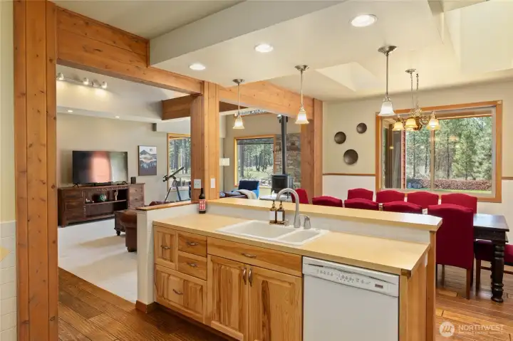 A light-filled kitchen with windows that bring in views of the landscaped yard.