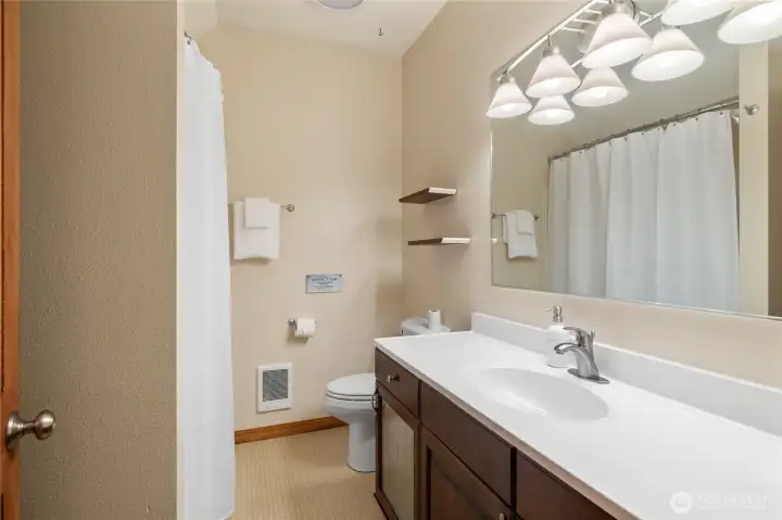 Guest bathroom with a tub and shower, perfect for visitors.