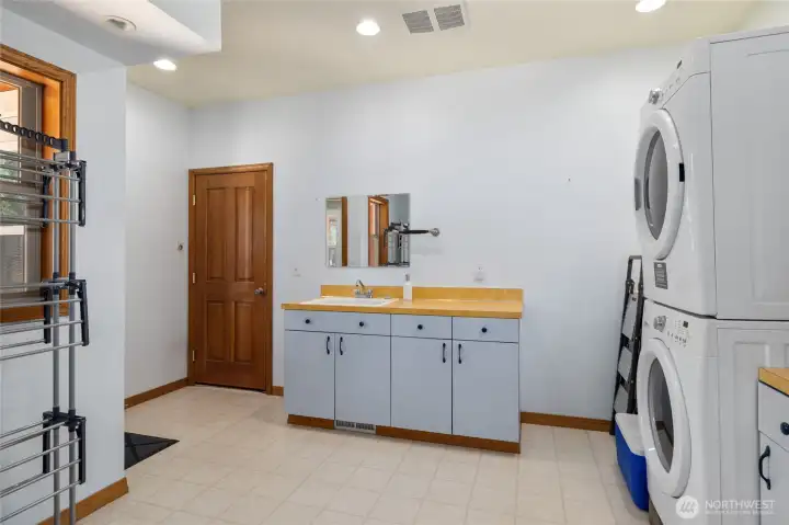 A large utility room with plenty of storage, washer and dryer, and a handy utility sink—practical and organized.