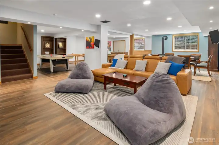 A bright and spacious finished basement, perfect for relaxing with the warmth of a woodstove.