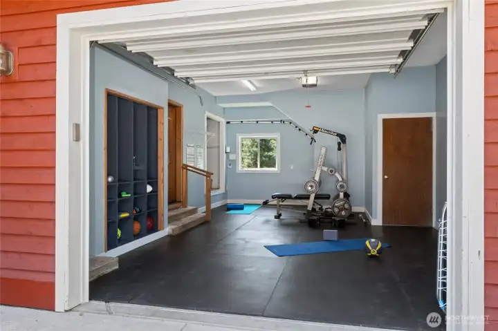 The attached garage has been transformed into a fully equipped gym for convenient workouts at home.
