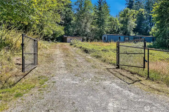 Cleared acre is fenced & gated across the front.