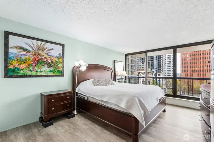 Large primary suite with NEW LVP flooring and floor to ceiling windows that step out to the second deck of this unit for an incredible view.