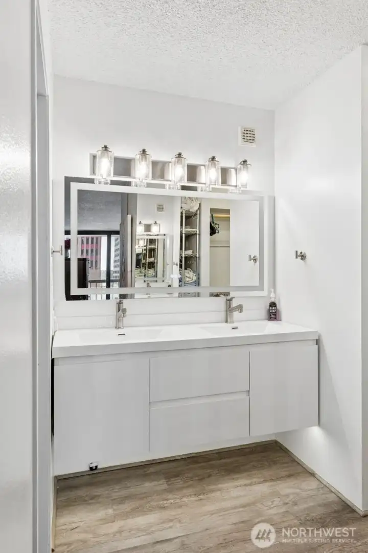 Nice new vanity with double sinks, updated lighting & mirror.