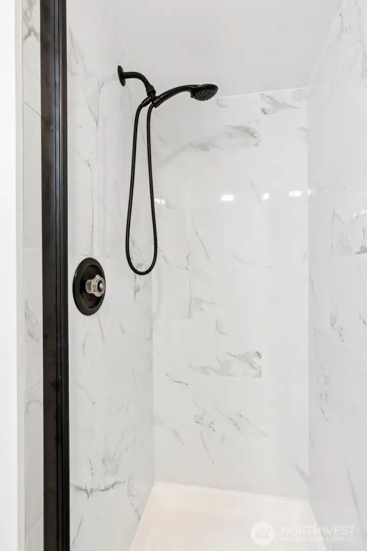 NEW tile shower in main hall bathroom-glass door & rubbed bronze fixtures.