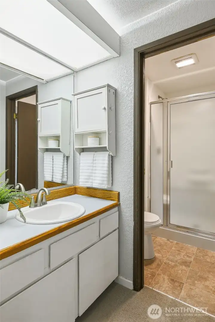 Primary bath vanity with a separate room for the shower and toilet—designed for added privacy and functionality