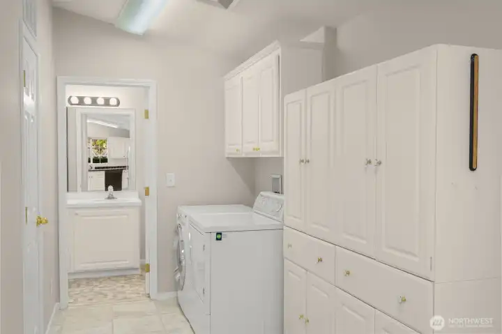Off the kitchen, enjoy the wide hallway with storage, laundry and access to guest bathroom.