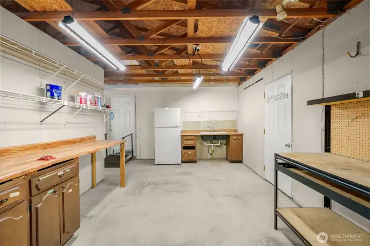 Workshop area of garage with large sink.  The 2nd refrigerator stays with the home.