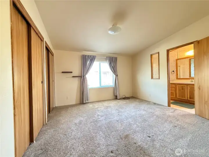 Primarly Bedroom with lots of closet space and attached bathroom with walk in shower