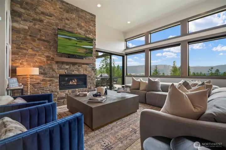Who wouldn't want to gather with family and friends around this gorgeous fireplace while enjoying that view