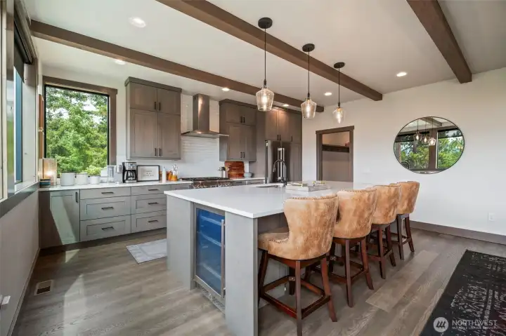 Handy beverage fridge tucked into the extra large kitchen island - keeps those drinks chilled and within arms reach while your guests are seated and chatting with the chef