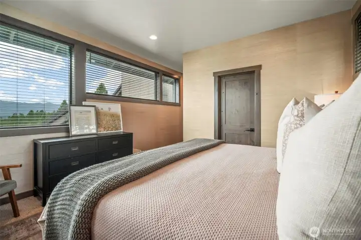 Upstairs primary suite is tucked away at the end of the hall for privacy and quiet enjoyment
