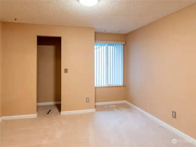 Primary bedroom, window looks out to the patio area.