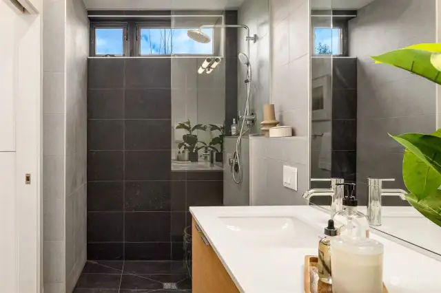 The main floor ensuite is thoughtfully designed with age-in-place features, such as a curbless shower, ensuring accessibility and convenience for all ages.