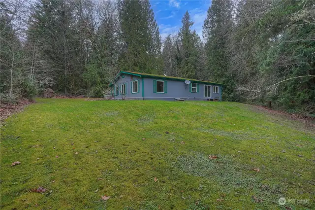 Triple wide manufactured home built in 2003 sits perched on her nearly 5 acre parcel.