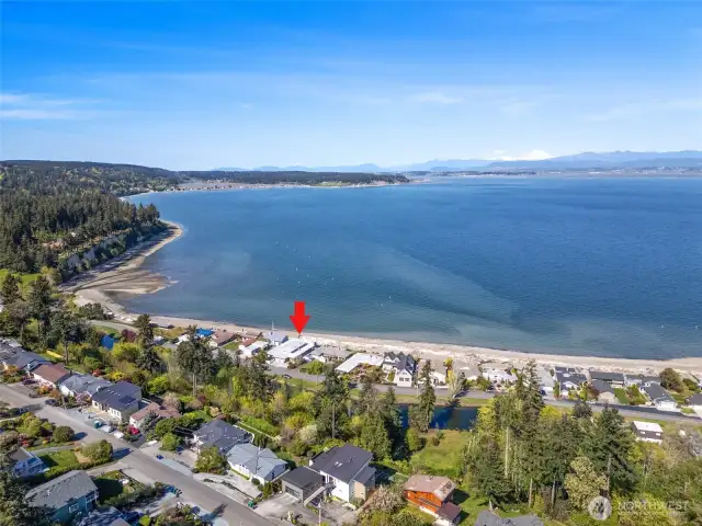 Situated right along the sandy beach of the Country Club on Camano Island, this home has stunning views of Port Susan Bay, Mount Baker, and the Cascade Mountain Range.