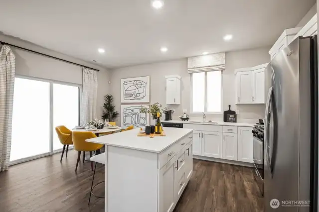 Dining space has bright slider that opens onto patio. Color scheme and options will vary. Photos from Model Home on 31. Homesite 45 is a mirror image