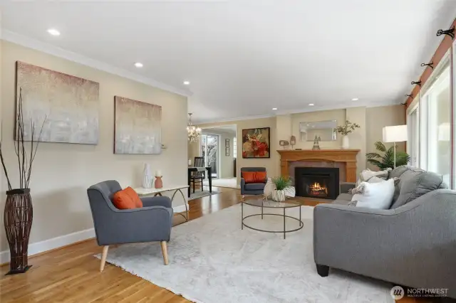 Light filled living room with original oak floors and gas fireplace
