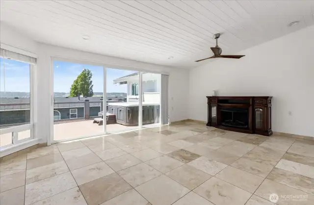 Upper level living room w/ electric fireplace.