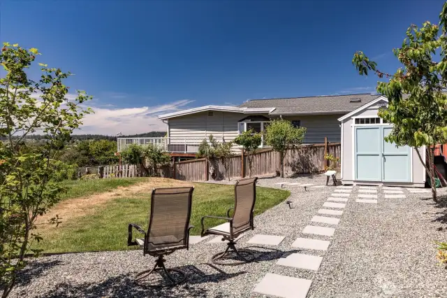 Garden-like backyard w/ fruit trees.
