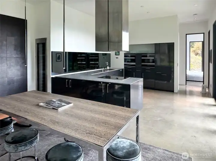 View from dining area to kitchen and primary bedroom door