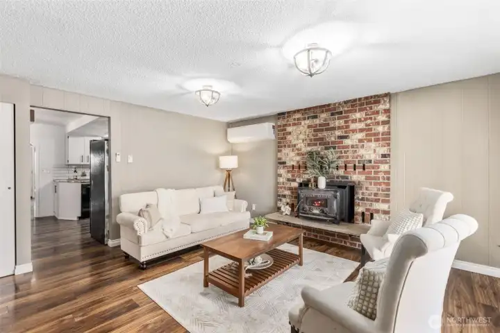 One of two living areas features beautiful natural light and a class Kodiak wood burning stove