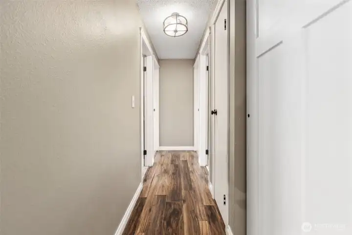Hallway leading to the bedrooms offer multiple closets for storage
