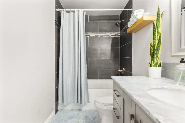 Updated full bathroom with deep tub, tile shower and tile floors