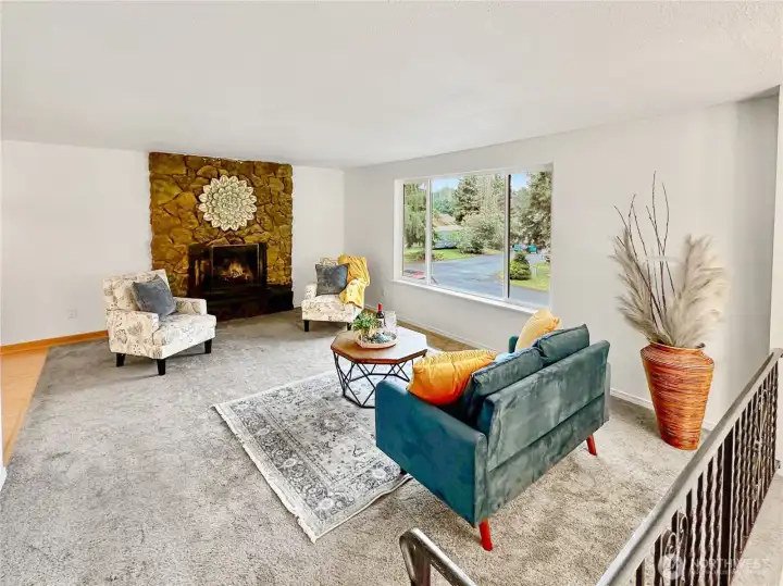 Generous main floor living room with wood burning fireplace.  Newer carpets & large windows let in plenty of light.