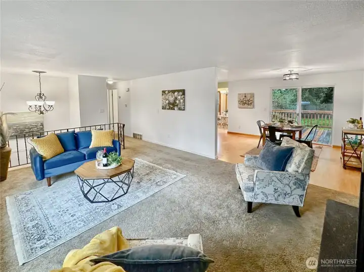 Another view of living area shows access to dining and kitchen.