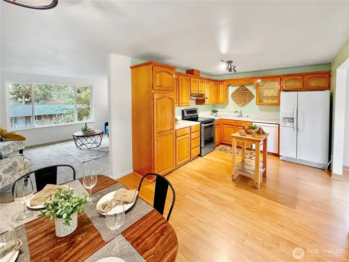 View of large open kitchen from dining room, access to charming nook off to the right.