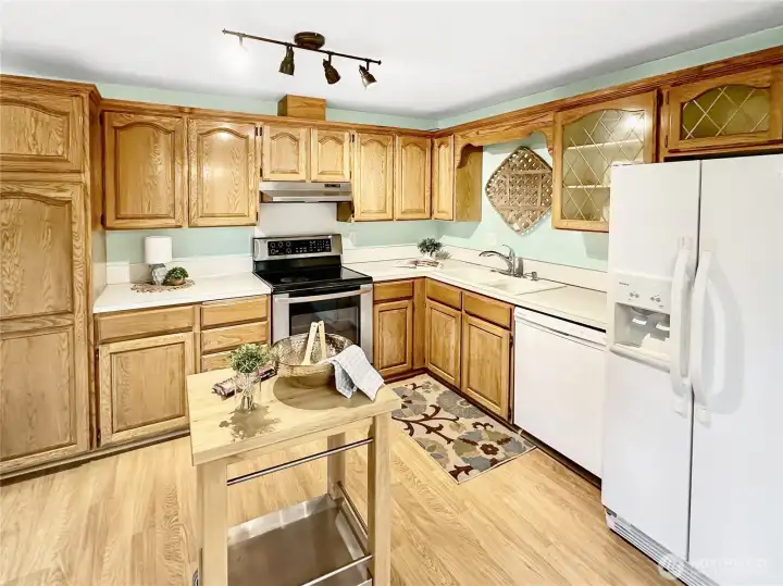 Close up of kitchen.  Laminate flooring and plenty of cabinets.