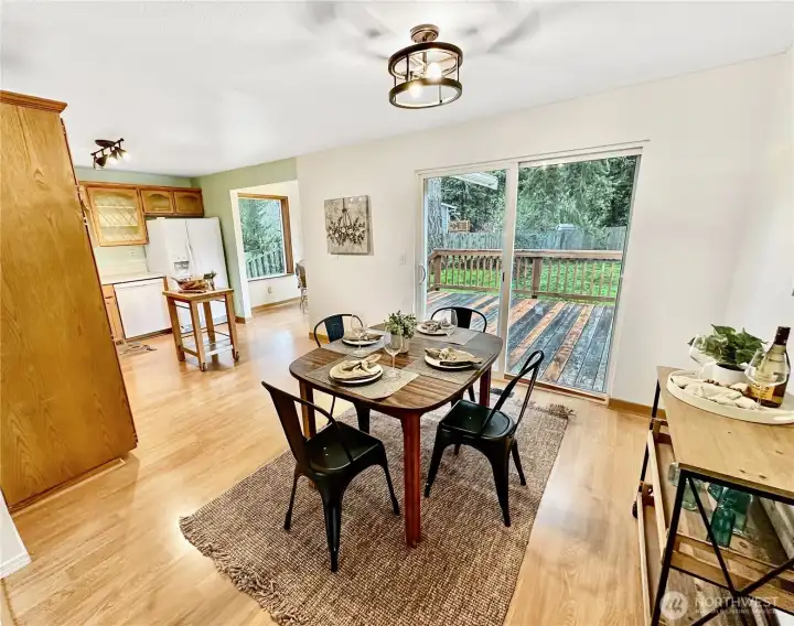 Dining room is large enough for a crowd with access to deck. Access to nook is to the left.