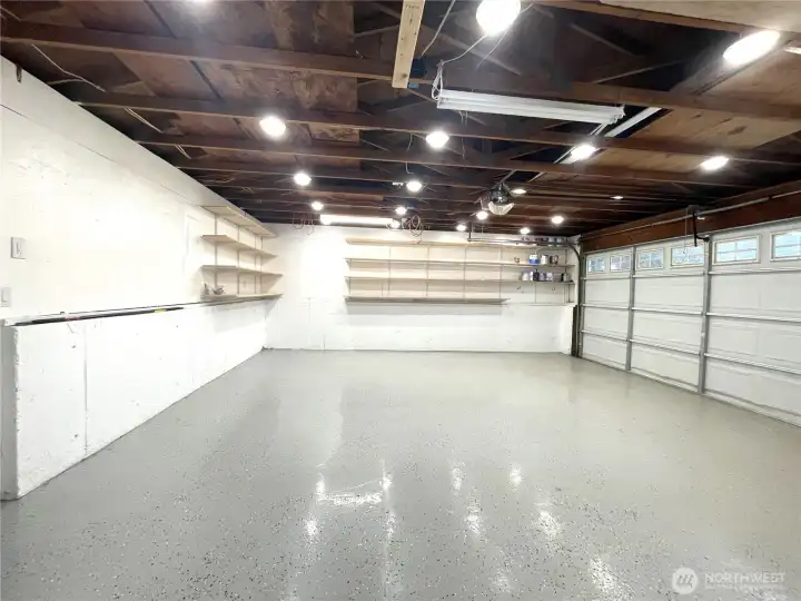 Ample garage with updated lighting and separate electrical panel.  EV ready, lots of shelving with access to rear yard. Perfect for shop/art studio.