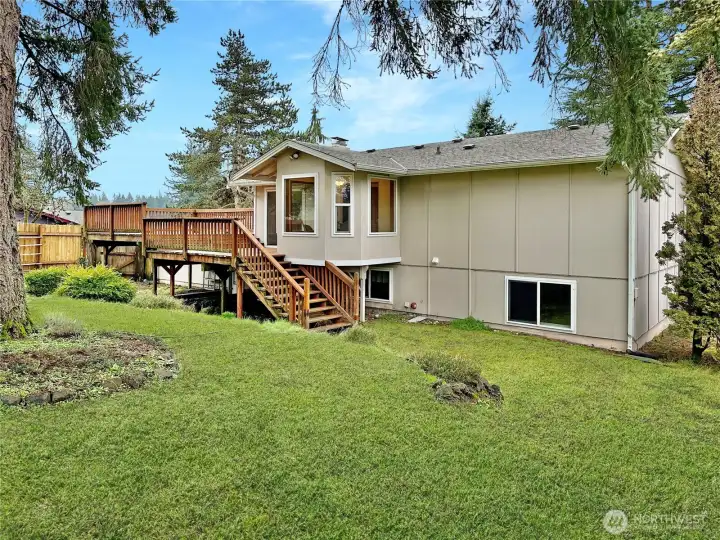 Ample rear yard is fenced with lots of room to garden and play.