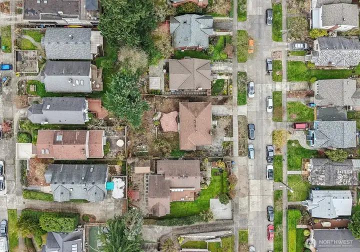 Set on a double-sized 6,000 sqft lot on a quaint tree-lined street with endless potential!