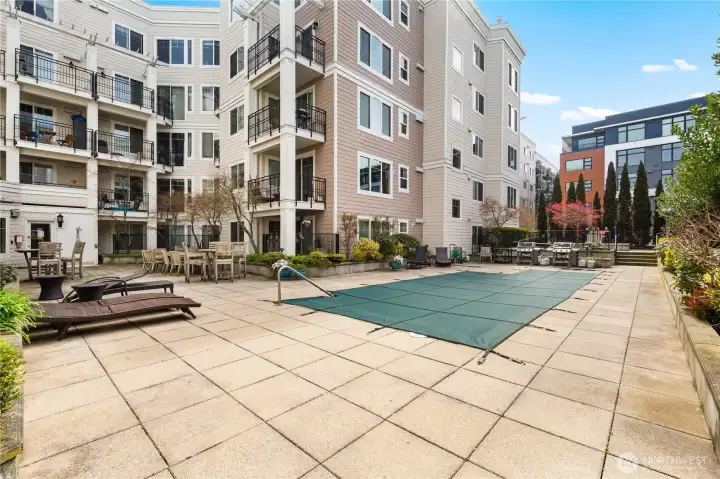 We've now walked outside into the courtyard and here's the pool, which will open next month/May. Further down in front of us is the hot tub. To the left and this photo is the door from which we come out of the building where the amenities are located, such as clubroom, gym, sauna.
