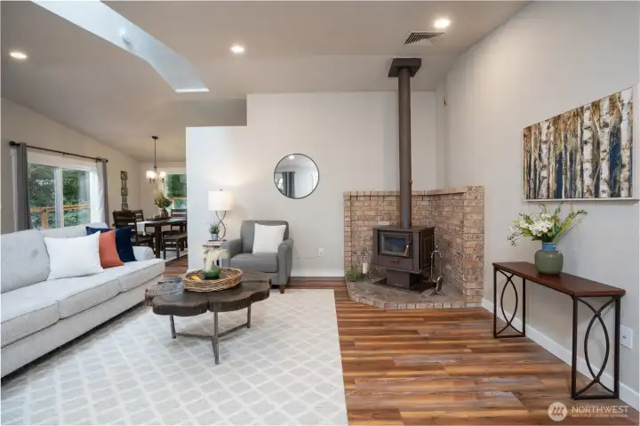 As you enter the home you are greeted by the fresh modern space & welcoming wood burning stove that's sure to keep you toasty warm in the winter months - dining room with slider to the back deck beyond.