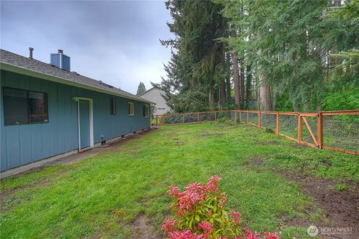 Nicely fenced backyard is a blank canvas for you to create your own private oasis. The green belt behind fence line is part of the property, giving you extra seclusion