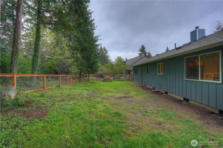 Another view of the back yard from the deck, a great spots for entire crew to roam. The fence leads to the back of the property's wooded section which is a nice privacy buffer.