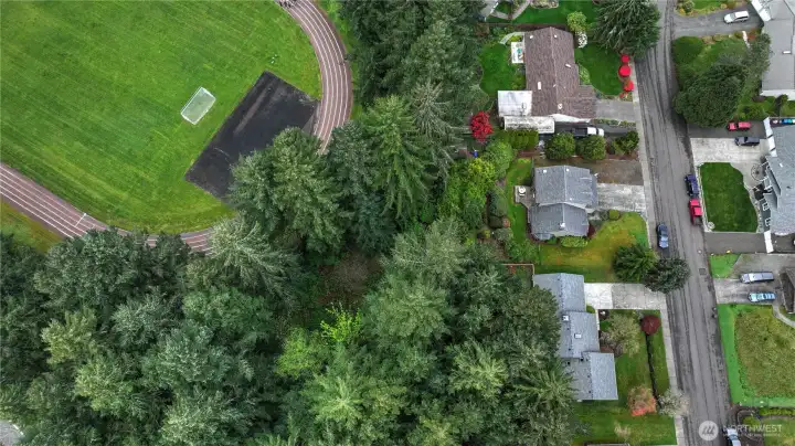 Drone view of the property and the back track at Komachin Middle School and road frontage on Stikes Loop Se