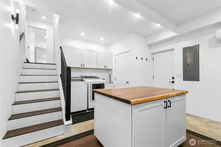 Downstairs laundry room with ample storage and folding island!
