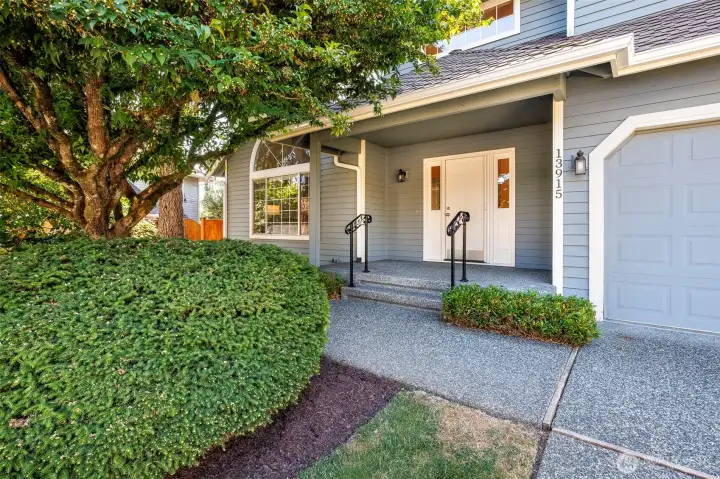 Large covered front porch; home has retractable front screen door.