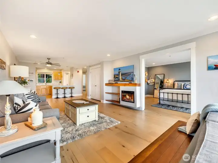 Seamless open layout connecting the living room, dining area, and kitchen with beautiful natural light.
