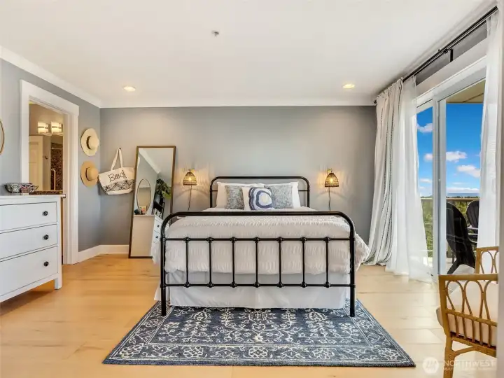 Spacious primary bedroom offers a peaceful retreat with abundant natural light and coastal ambiance.
