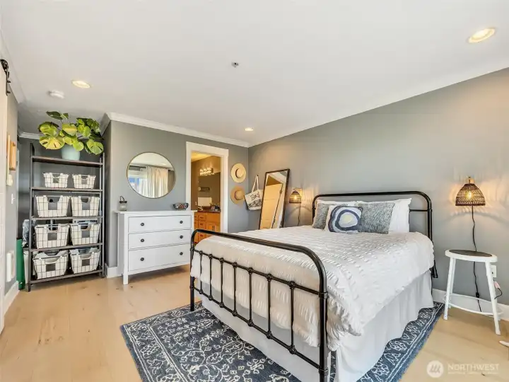 Generous primary suite with room for a sitting area and easy access to the ensuite bathroom.