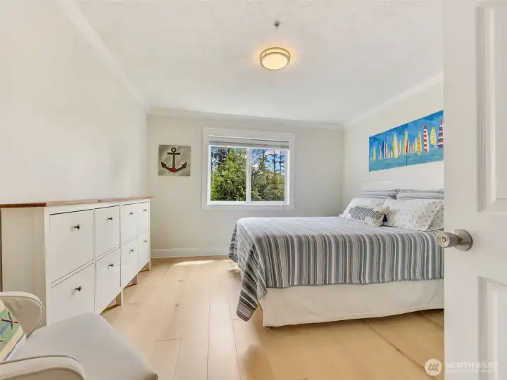 Comfortable guest bedroom provides flexible space for visitors, a home office, or additional sleeping accommodations.