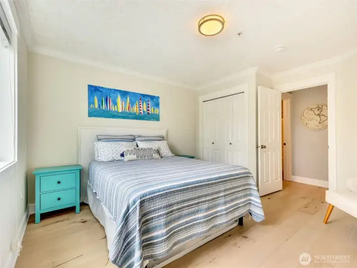 Spacious guest bedroom with abundant natural light, generous closet space, and comfortable accommodations for family and friends.